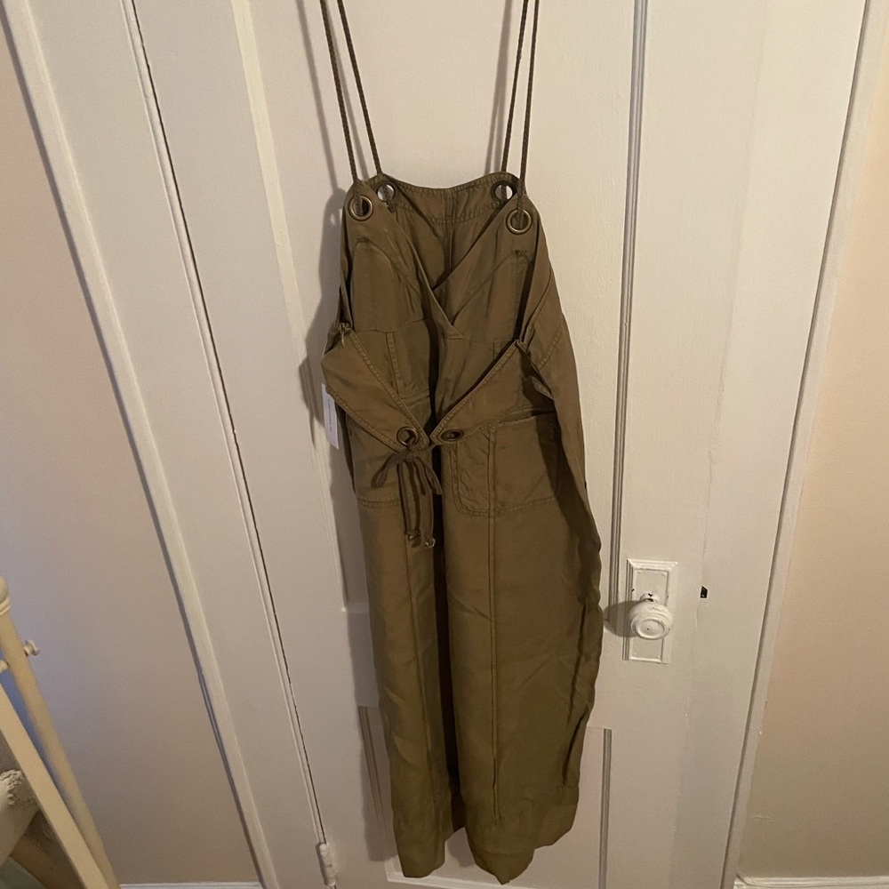 Army green jumpsuit worn with tank
